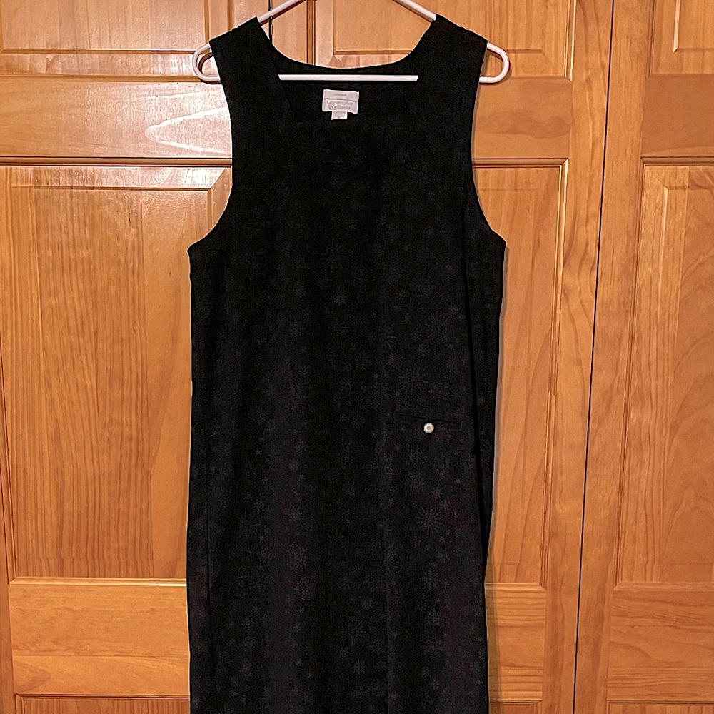 Black sheath jumper with snowflake imprinted design.
